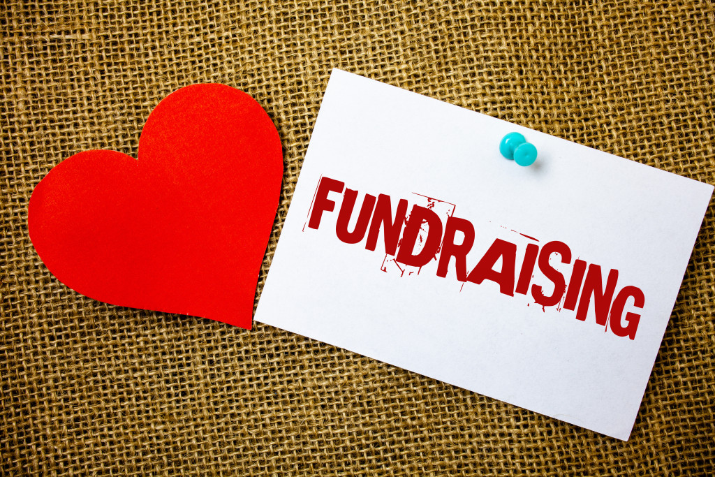 fundraiser envelope with a red heart cut out from paper beside it