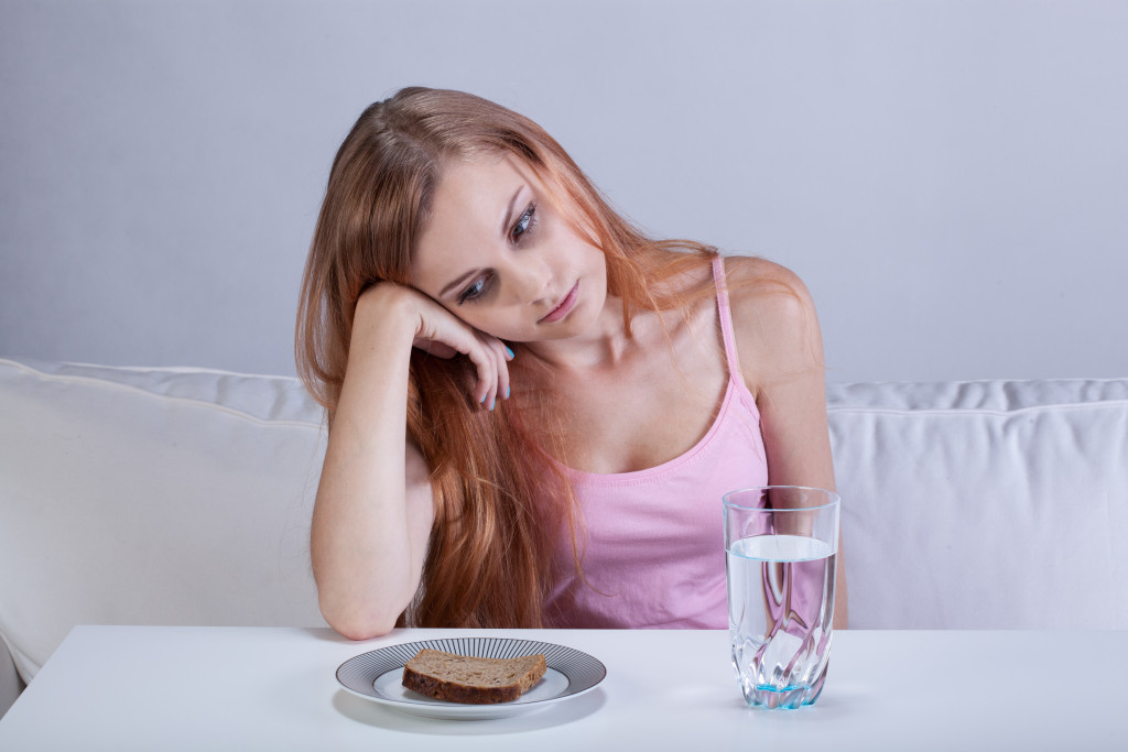 Portrait of young depressed girl with eating disorder
