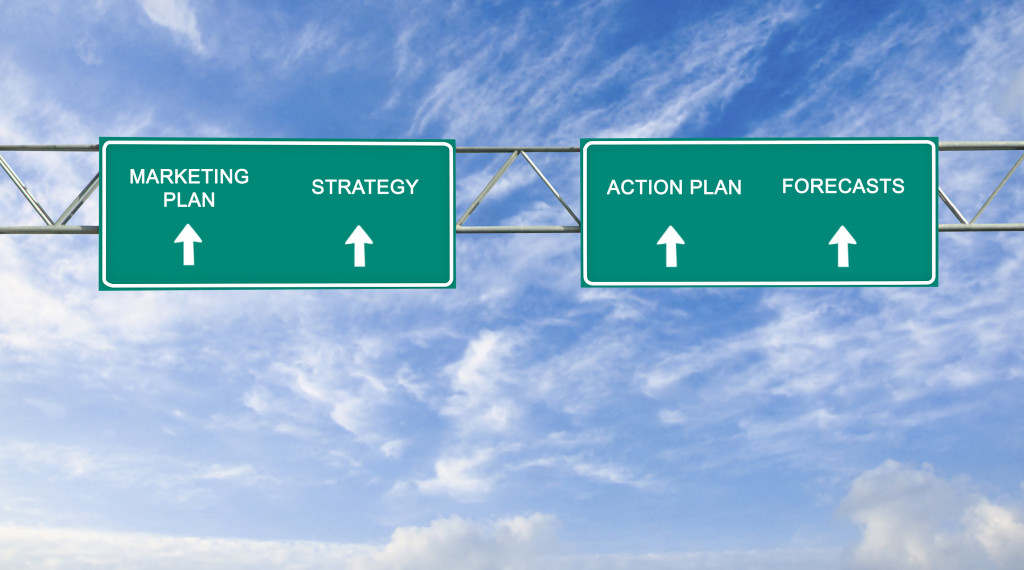 marketing plan, strategy, action plan, and forecasts road sign going upwards